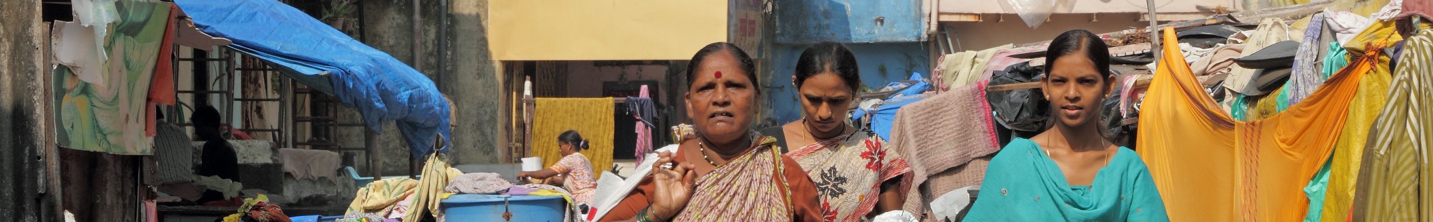 women walking in mumbai slum