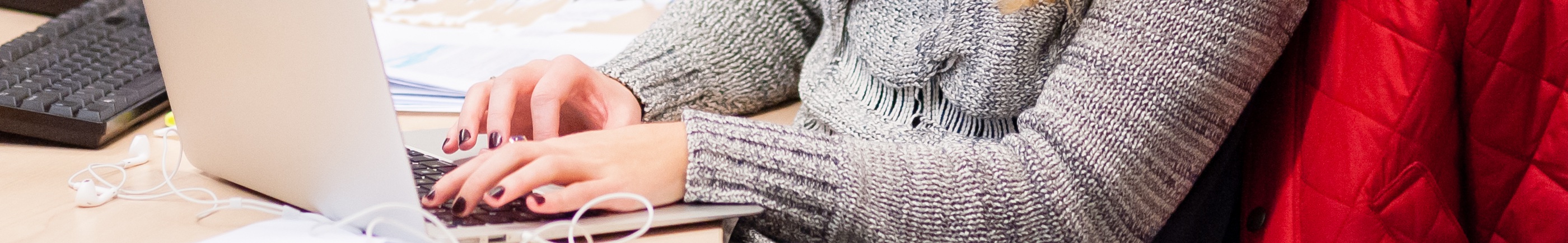 female hands typing on laptop